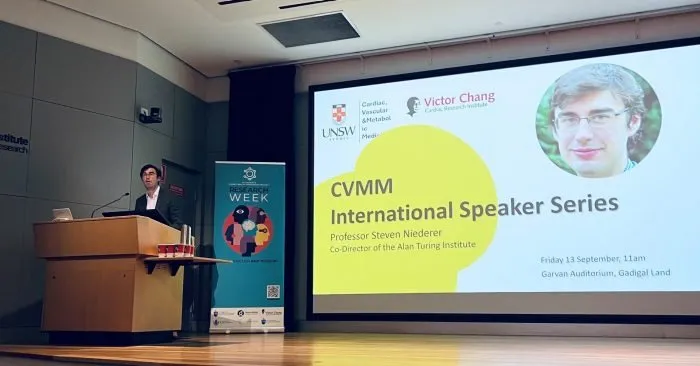 Steven Niederer lecturing in front of a slide of the CVMM International Speaker Series
