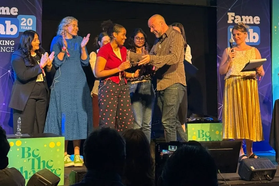 Tiffany Baptiste receiving her award on the FameLab stage at Cheltenham